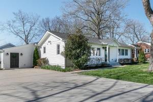 a white house with a driveway at King Suite Highland House of Historic Franklin in Franklin