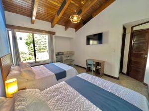 a hotel room with two beds and a television at Hotel Citadin Z10 in Guatemala +112 photos