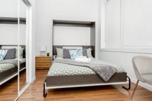 a bedroom with a bed and a mirror at Kensington Market Apartment in Toronto