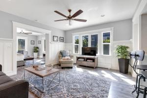 a living room with a couch and a ceiling fan at East Village Apartments in Long Beach