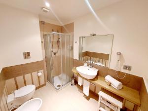 a bathroom with a shower and a toilet and a sink at Hotel La Villa Del Mare in Cagliari