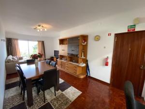 a living room with a table and a dining room at Inmaculado Apartment in Funchal