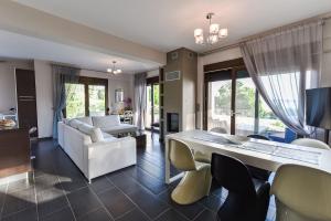 a living room with a white table and chairs at Villa Efmaria, Private Residence, Luxury villa, Neos Marmaras, Halkidiki in Neos Marmaras +43 photos