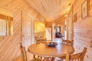 a wooden dining room with a wooden table and chairs at Black River Log Cabin Fish, Swim and Unwind! in Hatfield