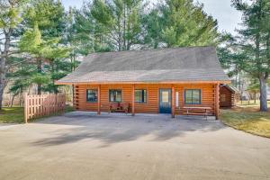 a log cabin with two benches and a fence at Black River Log Cabin Fish, Swim and Unwind! in Hatfield