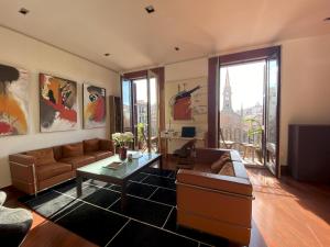 a living room with a couch and a table at Luminous Designer Loft Style Apt Eixample Views By MyRentalHost in Barcelona