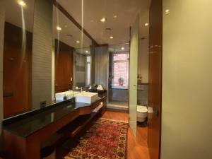 a bathroom with a sink and a toilet and a mirror at Luminous Designer Loft Style Apt Eixample Views By MyRentalHost in Barcelona