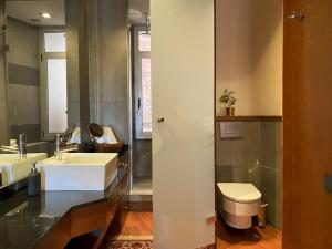 a bathroom with two sinks and a toilet at Luminous Designer Loft Style Apt Eixample Views By MyRentalHost in Barcelona