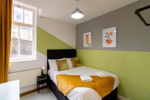 a small bedroom with a bed and a window at Great offers on Long Stays!! LaLuNa Apartments in Gateshead