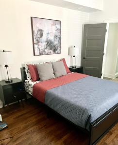 a bedroom with a bed with red and gray pillows at GROVE PARK- ‘Newly Renovated’ home- just mins from Midtown/Downtown Atlanta. in Atlanta