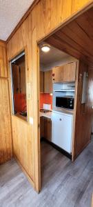 a small kitchen with a stove and a refrigerator at Résidence Sikkim - Studio pour 2 Personnes 764 in Aime-La Plagne