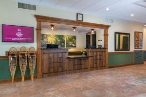 a waiting room with a waiting area with wooden doors at Best Western Plus Waterbury - Stowe in Waterbury