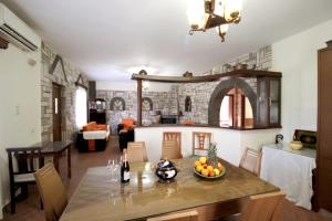 a living room with a table with a bowl of fruit on it at Garden Villa Dhesara in Ksamil