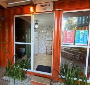 an entrance to a restaurant with a door open at Container Hospedaria Paraty in Paraty