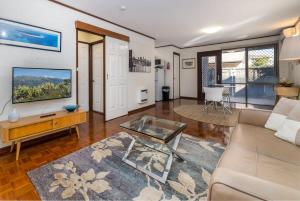 a living room with a couch and a table at Peaceful 1-Bed by City Centre with Secure Parking in Canberra