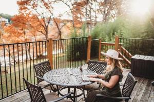 a woman sitting at a table on a patio at River's Edge in Wimberley +1 photo