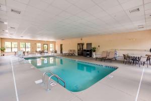 a pool in a large room with tables and chairs at Hampton Inn Dickson in Dickson