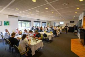 a group of people sitting at tables in a restaurant at Mildura Golf Resort in Mildura