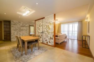 a dining room with a table and a couch at Kiluwa Apartments by Dunhill Serviced Apartments in Nairobi