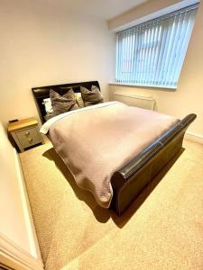 a bedroom with a large bed with a large window at Gem in Wellingborough in Wellingborough