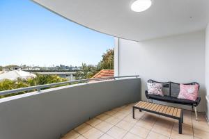 a balcony with a bench and a large window at Albion Convenient Hideaway with Parking & Balcony in Brisbane