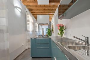 a kitchen with blue cabinets and a sink at Casa Gallo Firenze in Florence