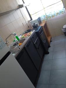 a small kitchen with a stove and a sink at AMANDA in Ciudad del Este