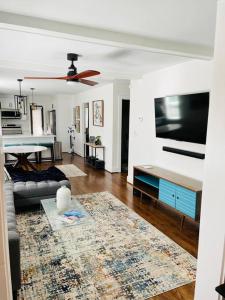 a living room with a couch and a flat screen tv at GROVE PARK- ‘Newly Renovated’ home- just mins from Midtown/Downtown Atlanta. in Atlanta