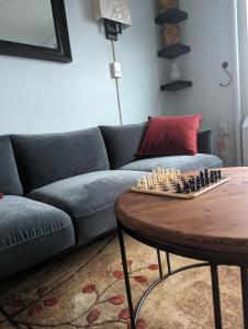 a living room with a couch and a chessboard on a table at Fully renovated Manhattan gem in New York