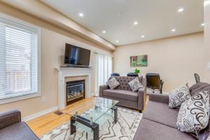 a living room with two couches and a fireplace at Avid vacation palace in Castlemore , Brampton in Brampton