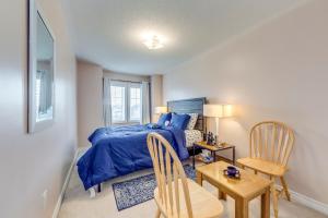 a bedroom with a bed and a table and chairs at Avid vacation palace in Castlemore , Brampton in Brampton