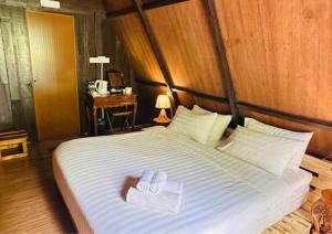 ein Bett mit zwei Handtüchern darüber in der Unterkunft Rustcamps Glamping Resort in Genting Highlands