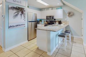 a kitchen with a refrigerator and a counter top at Maravilla 4409 in Destin
