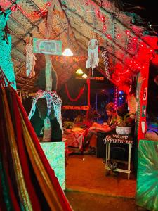 a room with red and blue lights and a room with people at Reggae paradise hostel in Sigiriya