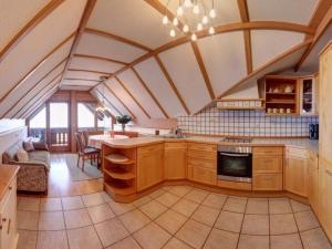 a kitchen with wooden cabinets and a table in a room at Staufenblick roof studio in the house in Inzell