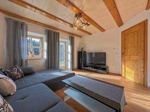 a living room with a couch and a tv at Ferienwohnung im Bayerischen Wald mit Terrasse in Viechtach