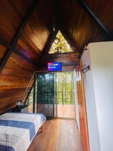 an attic room with a bed and a window at Chalet Cerro azul in Cerro Azul
