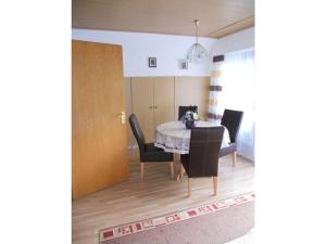 a dining room with a table and chairs at Apartment with beautiful sea view in Pappenheim