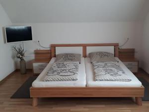 a bed with two pillows on it in a room at Apartment with beautiful sea view in Pappenheim