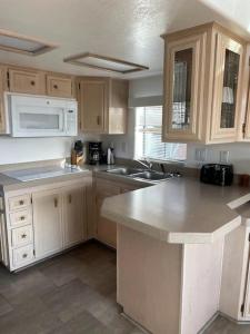 una cocina con armarios de madera y electrodomésticos blancos en Oceanview Cabin 25 W Jacuzzi & Pleasant Views, en Smith River