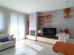 a living room with a couch and a television at Belvilla by OYO BOS03 3 in Grantola