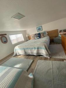 a bedroom with two beds and two rugs at Oceanview Cabin 19,jacuzzi, Large Deck W Seating in Smith River