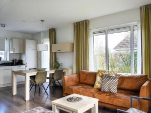 a living room with a couch and a table at Holiday home with sauna & outdoor spa in Earnewâld in Earnewâld