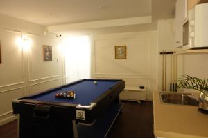 a room with a pool table in a kitchen at AboutTime Bangkok in Bangkok
