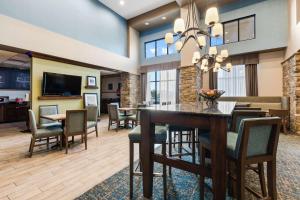 a dining room and living room with a table and chairs at Hampton Inn & Suites Colorado Springs-Air Force Academy/I-25 North in Colorado Springs