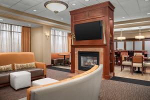 a living room with a fireplace and a flat screen tv at Hampton Inn Easton in Easton