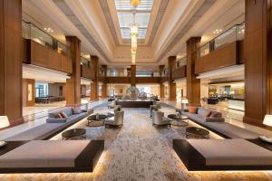a lobby with couches and chairs in a building at Hilton Odawara Resort & Spa in Odawara