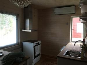 a kitchen with a stove and a sink in it at Grandma’s house in Iisalmi