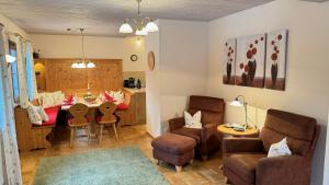 a living room with a table and a dining room at Ferienhaus Balsbergblick in Unterwössen