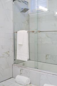 a bathroom with a shower with a white towel at Beautiful Irving two bedroom apartment in Philadelphia
